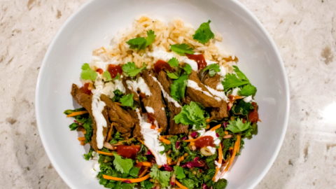 Bowl of steak, rice, and kale slaw