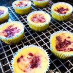 Individual strawberry cheesecakes on cooling rack