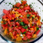 Chopped watermelon, bell pepper, red, onion and cilantro in bowl