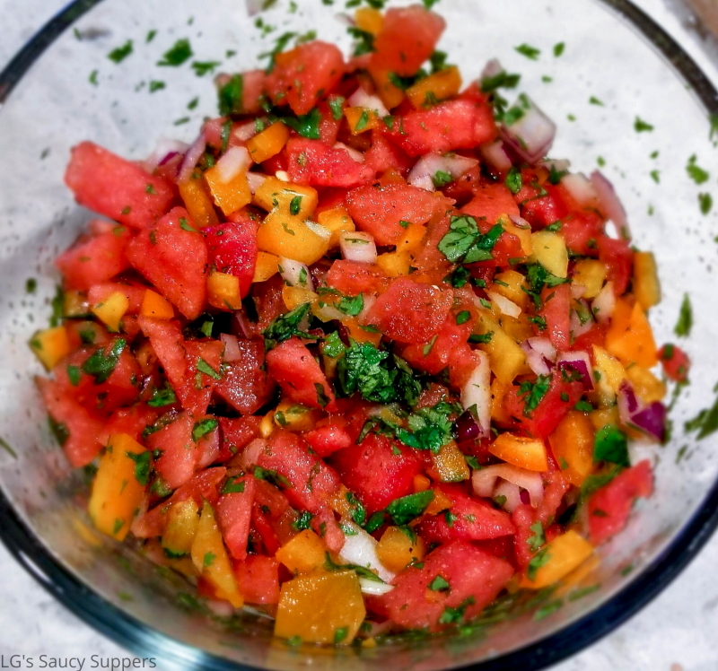 Chopped watermelon, bell pepper, red, onion and cilantro in bowl